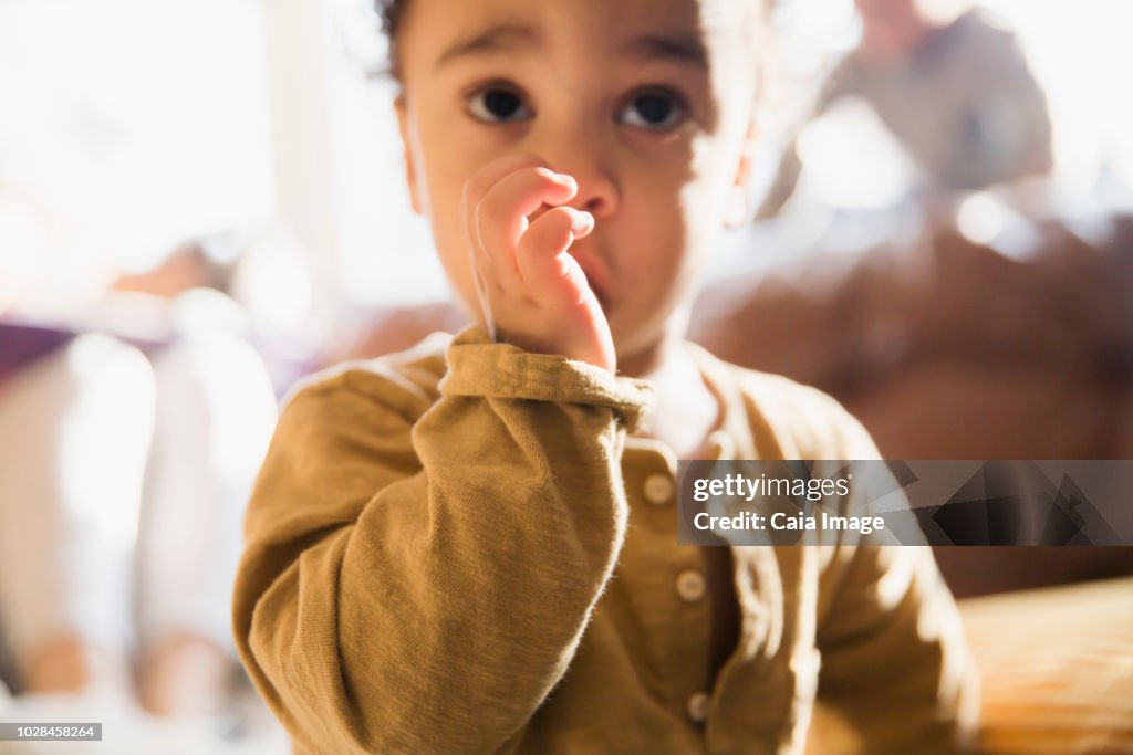 Close up innocent baby boy sucking thumb