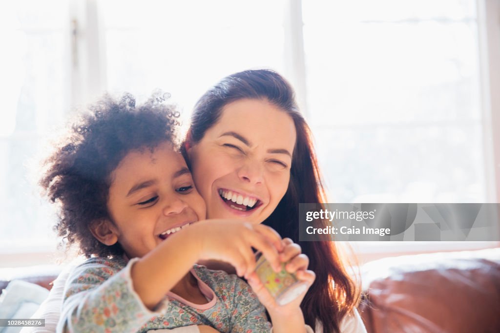 Laughing, carefree mother and daughter