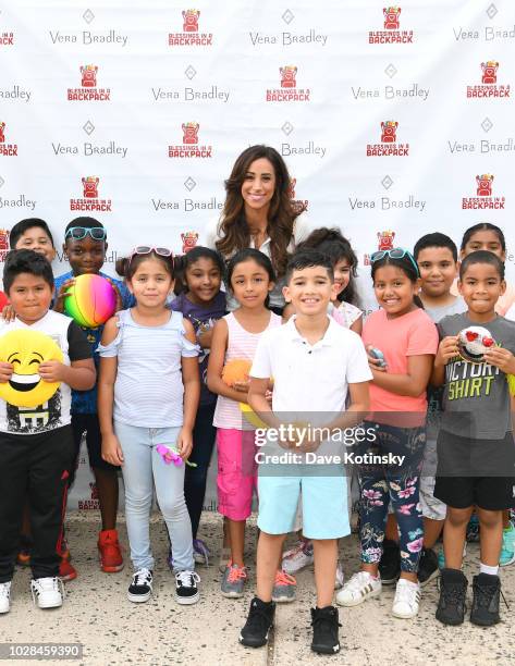 Social Influencer Danielle Jonas poses with students as she attends as Vera Bradley partners with Blessings In A Backpack to continue Back-To-School...