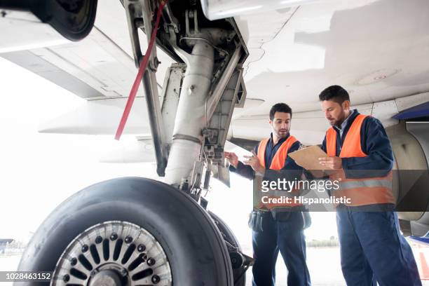 ground crew working at the airport - commercial airplane stock pictures, royalty-free photos & images