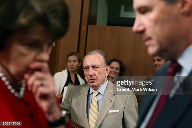 Sen. Dianne Feinstein speaks with Sen. Sheldon Whitehouse , while Sen. Arlen Specter stands nearby before the start of a Senate Judiciary Committee...