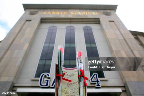 Candle and two roses sit in front of Gate 4 at Yankee Stadium, after the death of George Steinbrenner July 13, 2010 in the Bronx borough of New York...