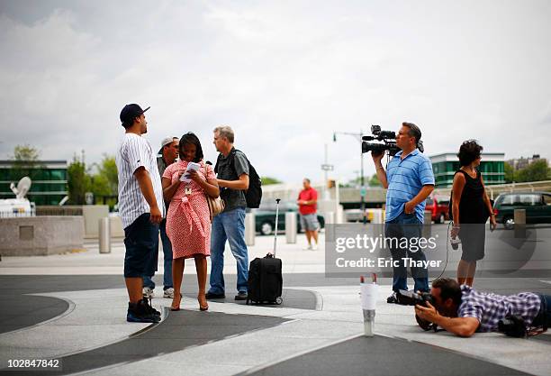 Members of the media interview Yankees fan Danny Taveras from the Bronx, at Gate 4 of Yankee Stadium, after the death of George Steinbrenner July 13,...