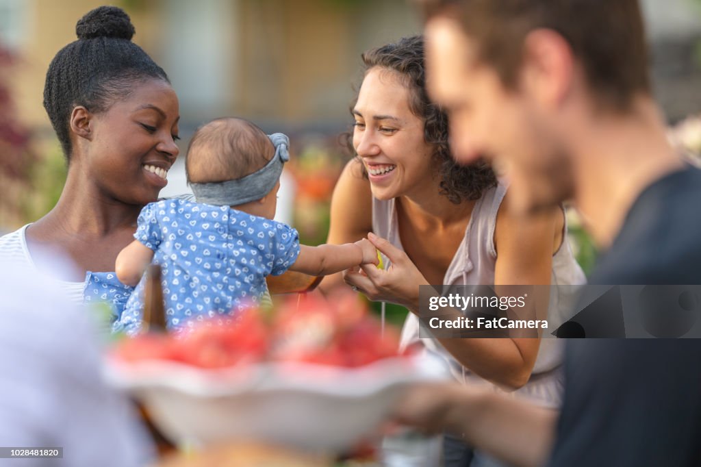 A group of young adult friends dining al fresco on a patio