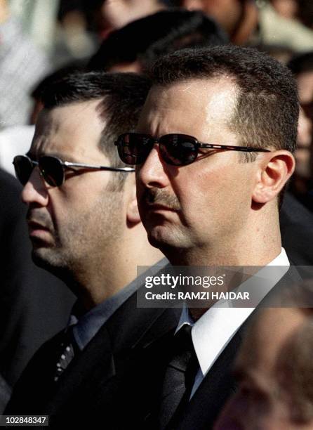 The sons of Syria's late President Hafez al-Assad, Maher and heir apparent, Bashar , march behind their father's coffin during his funeral in...