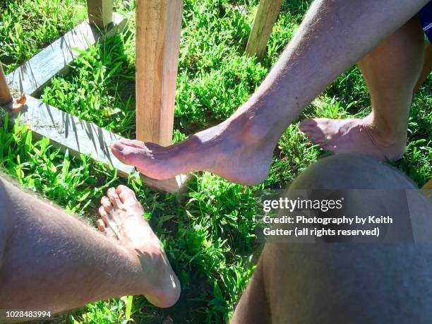 summertime outdoors barefoot friendship - footsie under table stock pictures, royalty-free photos & images