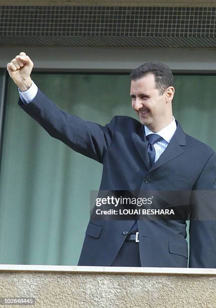 Syrian President Bashar al-Assad salutes the crowd during a demonstration in Damascus 09 March 2005. Tens of thousands of people converged on...