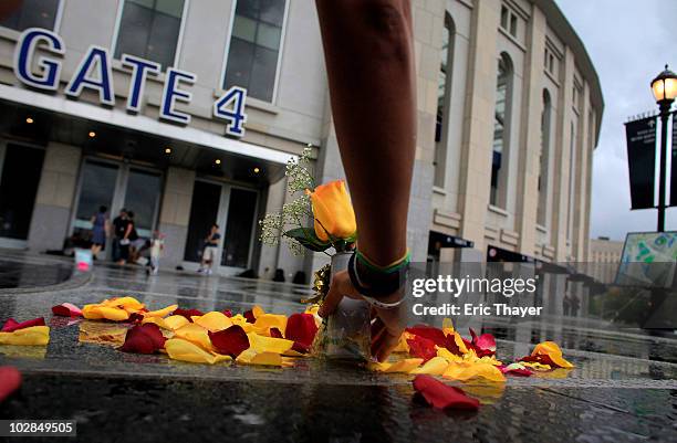 Fan Mary Byrne of Saddlebrook, New Jersey, places a rose in front of Gate 4 at Yankee Stadium, after the death of George Steinbrenner July 13, 2010...