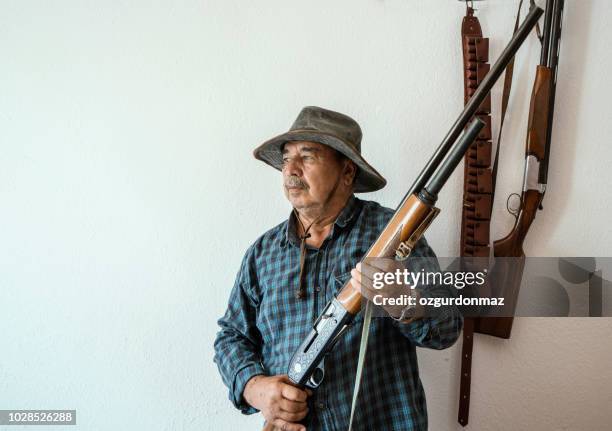 senior man holding a shotgun - turkey hunting stock pictures, royalty-free photos & images