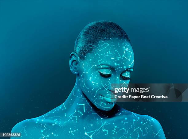 woman with constellations glowing on her face - astrología fotografías e imágenes de stock