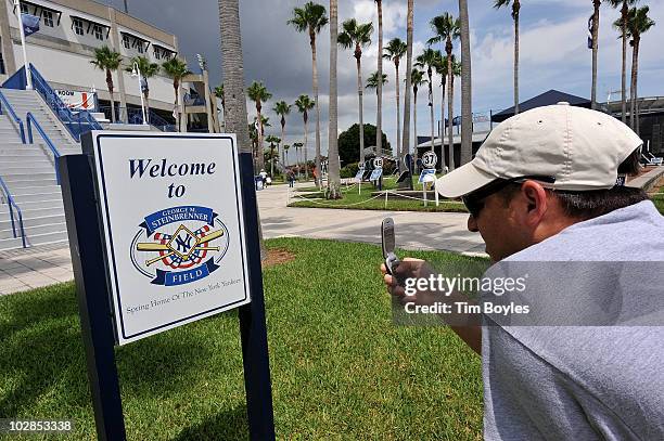 Ian Cohen takes a photograph of the sign outside of George M. Steinbrenner Field, after the death of George Steinbrenner on July 13, 2010 in Tampa,...