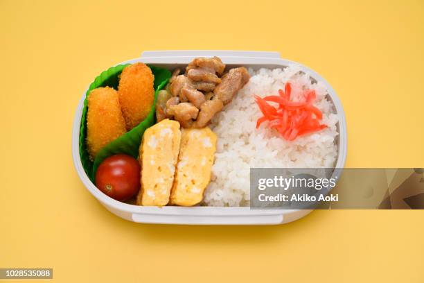 bento box lunch on yellow background. - packed lunch stock pictures, royalty-free photos & images