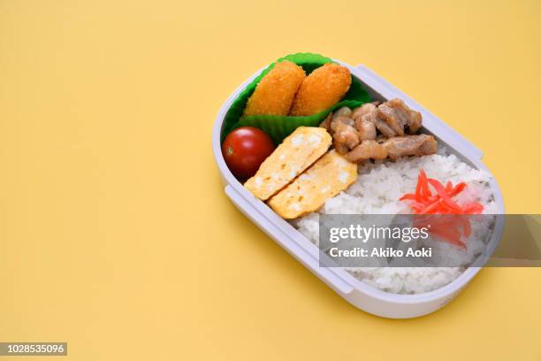 bento box lunch on yellow background. - chicken saute stock pictures, royalty-free photos & images