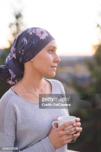 woman battling cancer stands outside and contemplates her life - critical illness stock pictures, royalty-free photos & images