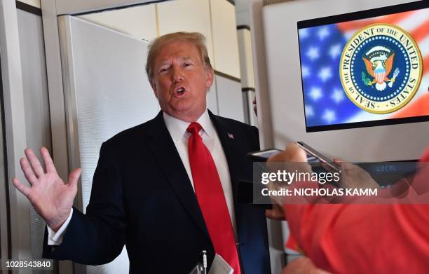 President Donald Trump speaks to the press aboard Air Force One on September 7 as he travels to Fargo, North Dakota, to speak at a Joint Fundraising...