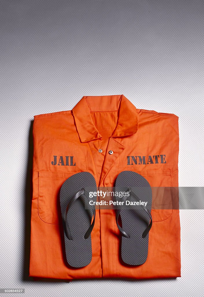 Orange jump suit in prison cell