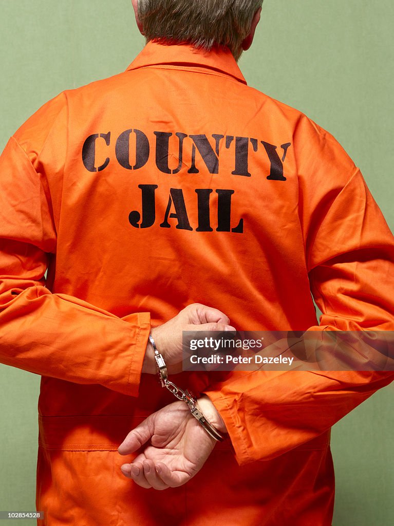 Senior county jail prisoner in hand cuffs