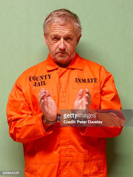 senior man in hand cuffs - gevangene stockfoto's en -beelden