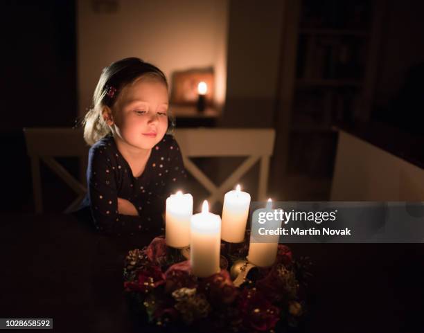little child watching lights of advent wreath - kids advent stock pictures, royalty-free photos & images