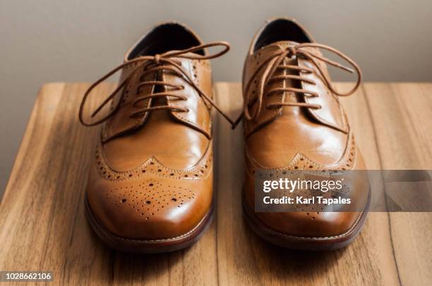 a pair of brown derby shoes with full brogue - smart shoes stock pictures, royalty-free photos & images