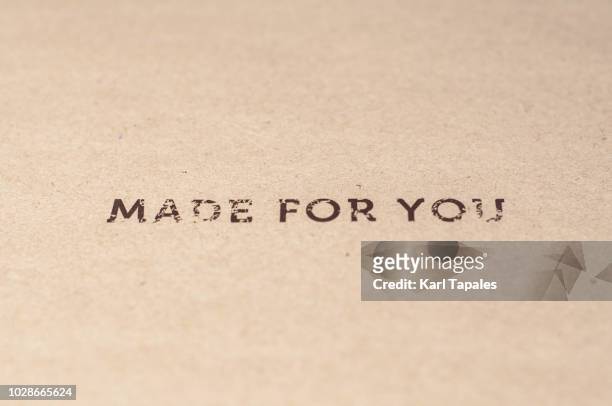 a "made for you" sign written on a brown paper - customized stock-fotos und bilder