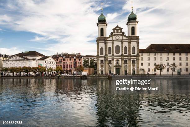 the jesuit church and the famous chapel bridge in lucern - jesuit stock-fotos und bilder