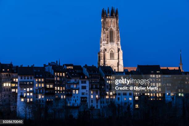 twilight over the fribourg cathedral in switzerland - fribourg canton stock pictures, royalty-free photos & images