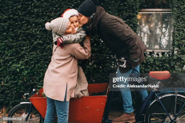 family enjoy cargo bike ride - winter cycling stock pictures, royalty-free photos & images