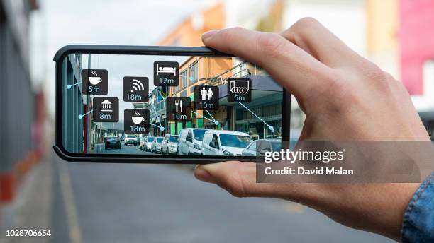 augmented reality of a city street shown on a mobile device. - realtà aumentata foto e immagini stock