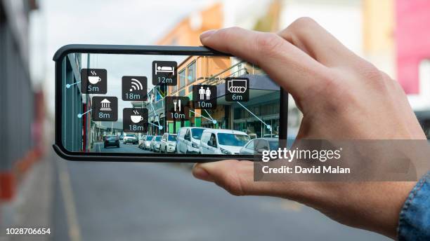 augmented reality of a city street shown on a mobile device. - augmented reality stock pictures, royalty-free photos & images