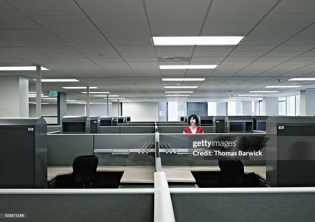 Businesswoman standing alone in empty office