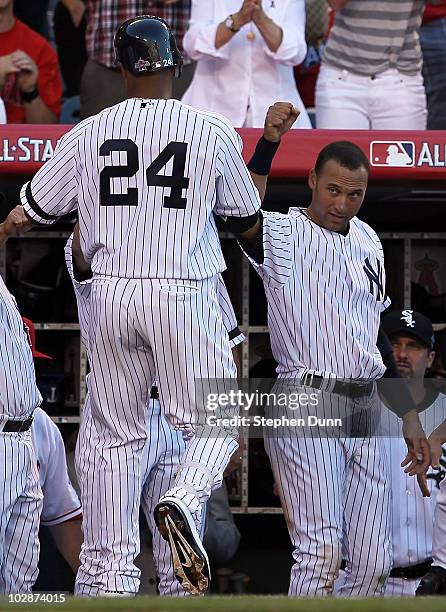 American League All-Star Robinson Cano of the New York Yankees on his way into the dugout after hitting a sacrifice fly to score American League...