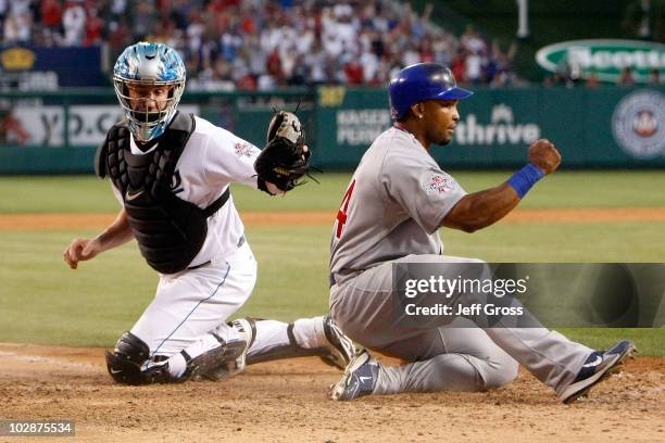 National League All-Star Marlon Byrd of the Chicago Cubs reacts after sliding in safe at home plate to score the third run for the National League in...