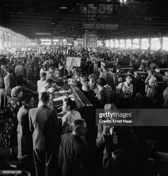 Refugees at Ellis Island, New York, 1951. They have recently arrived on board the USS General R. M. Blatchford, which brought displaced persons from...