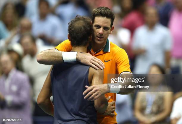 Rafael Nadal of Spain hugs Juan Martin del Potro of Argentina after he is forced to retire due to injury in his men's singles semi-final match on Day...