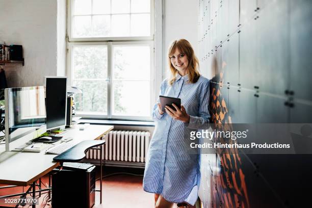 portrait of startup business owner at her office - entrepreneur portrait stock pictures, royalty-free photos & images