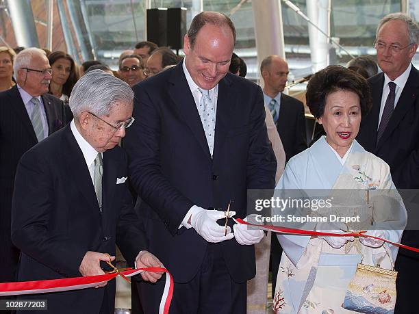 Prince Albert II of Monaco and Prince Hitachi of Japan with his wife Princess Hitachi of Japan cut the ribbon during the opening ceremony of the art...