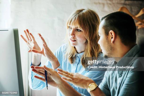 colleagues problem solving at computer together - kommunikation bildbanksfoton och bilder