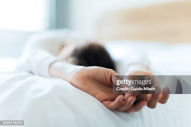 woman relaxing on a bed. - travesseiro imagens e fotografias de stock