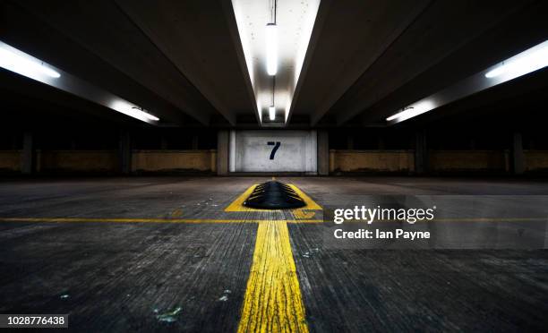 symmetrical parking garage with large number 7 on the wall - 数字の7 ストックフォトと画像