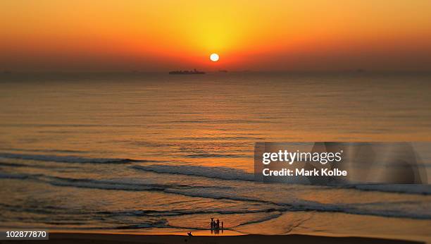 Baptism is performed as the sunrises over the Indian Ocean on June 19, 2010 in Durban, South Africa.