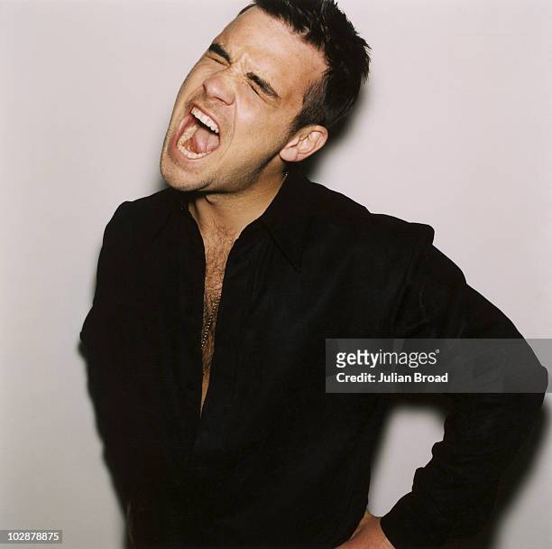 Singer Robbie Williams poses for a portrait shoot in London.