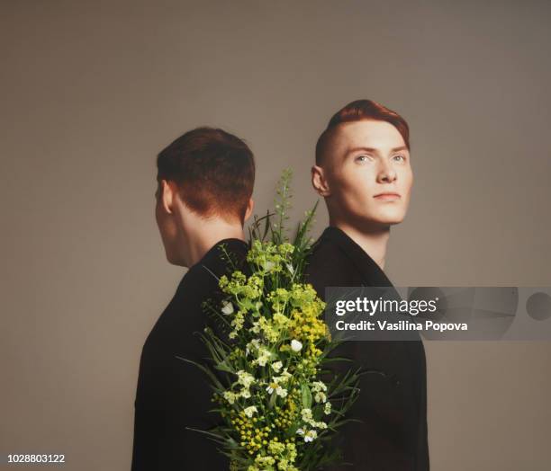 collage with male twins and flowers - poträt mann frühling stock-fotos und bilder