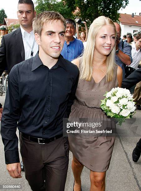 Bayern Muenchen football player Philipp Lahm and his new wife Claudia Schattenberg leave after their civil wedding at the city hall of Aying on July...