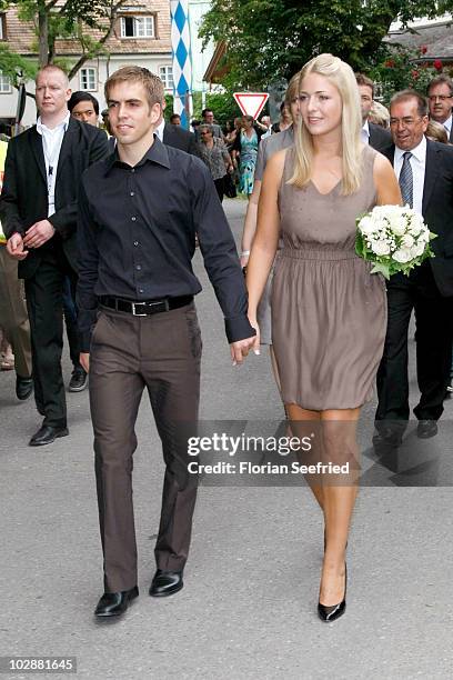 Bayern Muenchen football player Philipp Lahm and Claudia Schattenberg arrive for their civil wedding at the city hall of Aying on July 14, 2010 in...