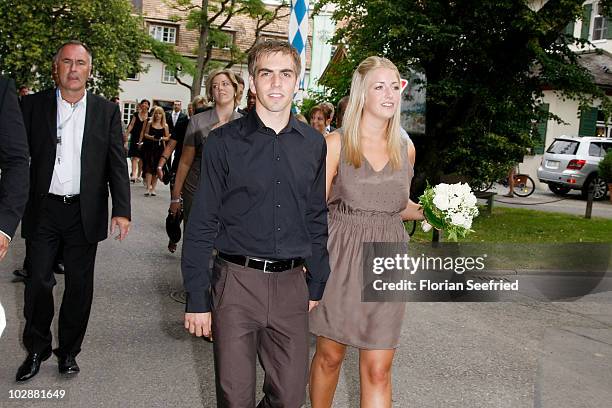 Bayern Muenchen football player Philipp Lahm and Claudia Schattenberg arrive for their civil wedding at the city hall of Aying on July 14, 2010 in...