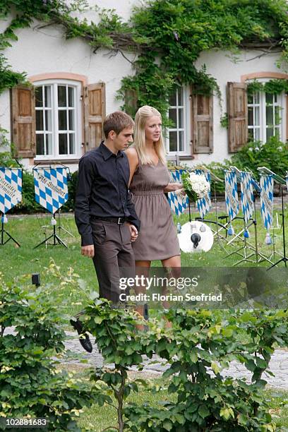 Bayern Muenchen football player Philipp Lahm and Claudia Schattenberg arrive for their civil wedding at the city hall of Aying on July 14, 2010 in...