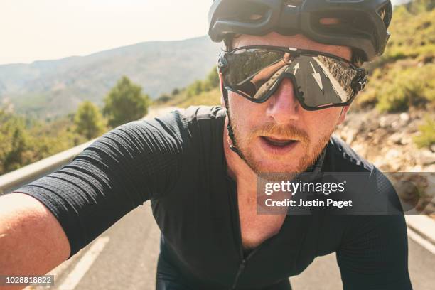 man taking selfie whilst cycling - 自分撮り ストックフォトと画像