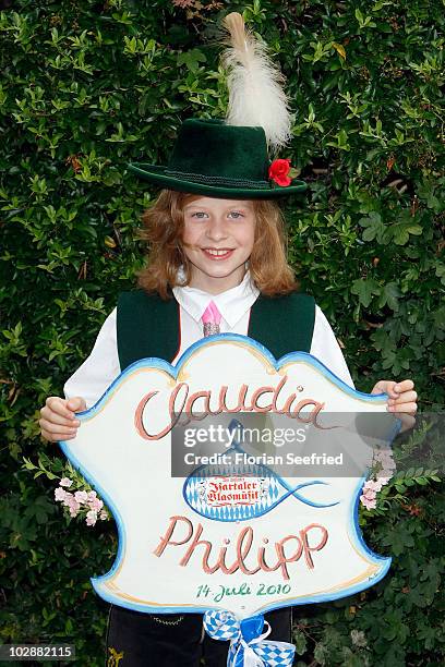 Child with a sign at the civil wedding of FC Bayern football player Philipp Lahm and Claudia Schattenberg at the city hall of Aying on July 14, 2010...