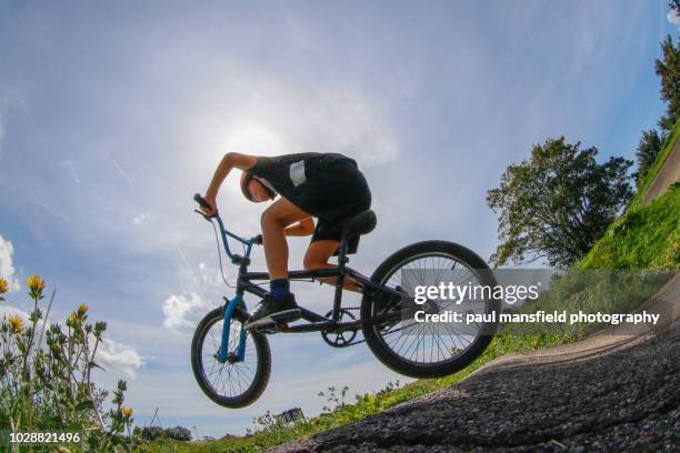 boy jumping on his bmx bicycle - youth culture speed stock pictures, royalty-free photos & images